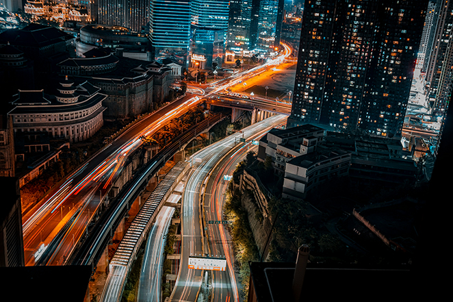 Light trails from traffic at night, suggesting motion compressed in time