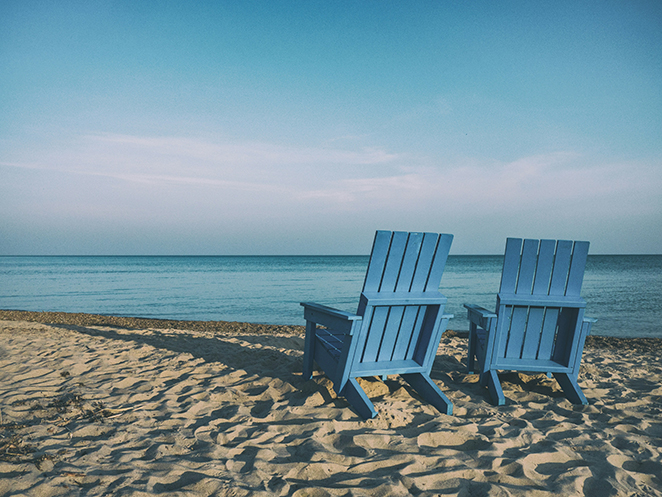 Two chairs on a beach - suggesting peaceful retirement.